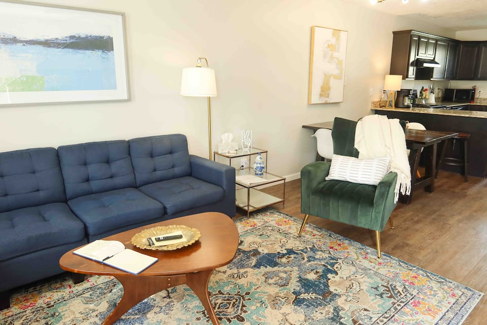511A living room with a blue sofa and green chair