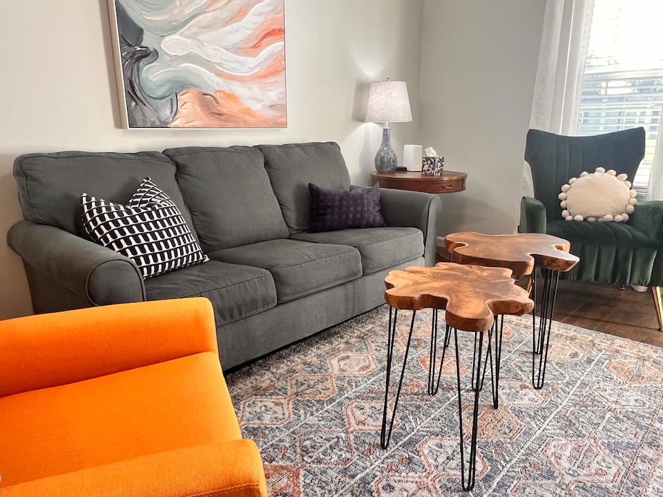 511B living room with a gray sofa and orange chair